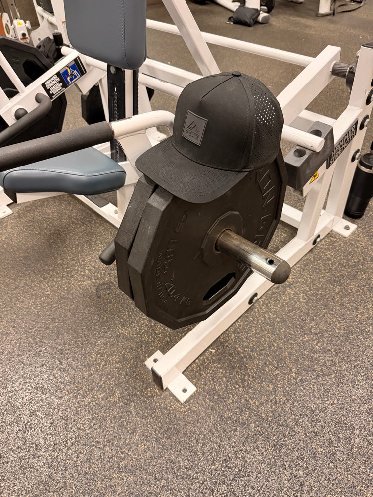 PEAK hat on gym weight plate