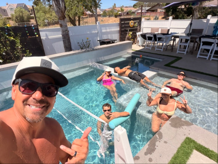 Friends wearing PEAK hats at pool party